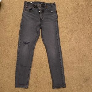 Women’s Levi’s 501 S, faded black, hole at right knee, SZ W25 x L28, Used.